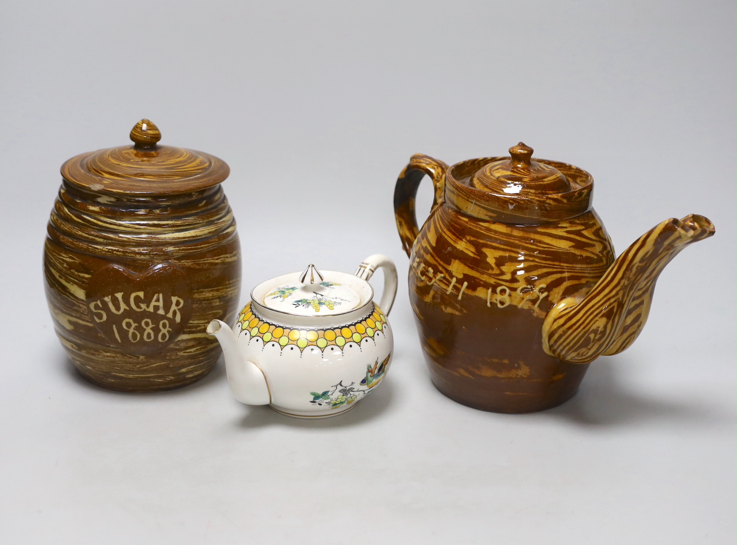 Two 19th century and later teapots including and a Harrods Stella example lidded pottery sugar jar dated 1888, the largest 20cm high